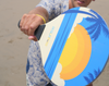 Man playing paddle ball bat in the beach 