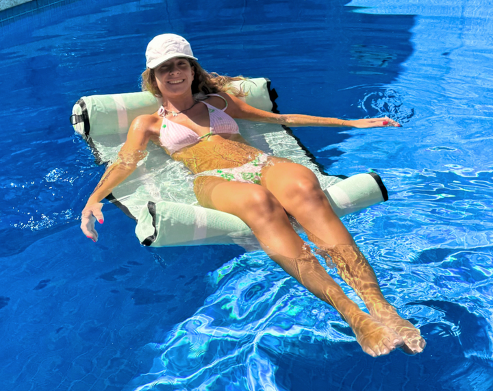 Woman using a Mint Green water hammock float by acquaboss. Include Floating Drink Holder and a Waterproof Insulated Phone Bag